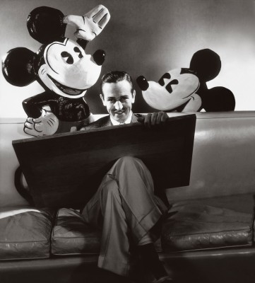 ca. October 1933, USA --- Walt Disney seated with drawing board on his lap and representations of his creations Mickey and Minnie Mouse behind. --- Image by © Condé Nast Archive/Corbis