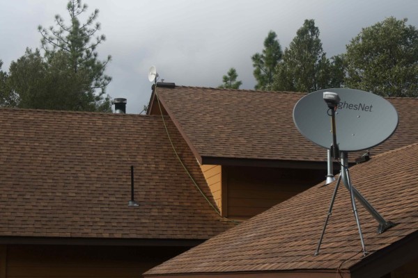 HughesNet satellite dish in the foreground, Com-Pair Services in the back.