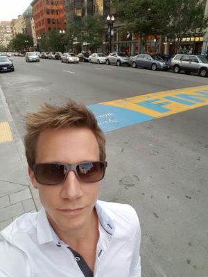 Scott Seaton at the Boston Marathon finish line, proving it's never too early to practice.