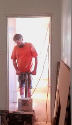 Corey Bunton sanding the back bedroom floor.